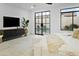 Stylized bedroom features natural light, modern furniture, and glass doors to pool area at 7774 E San Fernando Dr, Scottsdale, AZ 85255