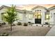 Charming home's exterior features a well-maintained desert landscape and inviting entrance with black metal gate at 7774 E San Fernando Dr, Scottsdale, AZ 85255