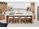 Gourmet kitchen with a large island, modern appliances, and stylish barstool seating at 7774 E San Fernando Dr, Scottsdale, AZ 85255