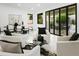 Bright living room featuring modern decor, tile floors, and glass doors leading to an outdoor patio at 7774 E San Fernando Dr, Scottsdale, AZ 85255