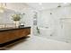 Elegant main bathroom featuring a standalone tub, glass-enclosed shower, and modern vanity with custom cabinetry at 7774 E San Fernando Dr, Scottsdale, AZ 85255