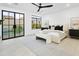 Main bedroom with an abundance of natural light, pool view, decorative rug, and modern ceiling fan at 7774 E San Fernando Dr, Scottsdale, AZ 85255