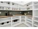 Walk-in pantry with custom shelving, butcher block countertop, and olive-green tile backsplash at 7774 E San Fernando Dr, Scottsdale, AZ 85255