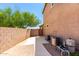 Spacious backyard with block wall, walkway, greenery, and equipment at 778 W Lowell Dr, San Tan Valley, AZ 85140