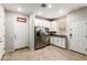 A well-lit kitchen with stainless steel appliances, white cabinetry, and tile floors at 778 W Lowell Dr, San Tan Valley, AZ 85140