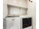 Bright laundry room features a Maytag washer and dryer with a shelf for storage at 778 W Lowell Dr, San Tan Valley, AZ 85140