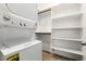 Bright laundry room with stackable washer and dryer and built-in shelving for storage at 778 W Lowell Dr, San Tan Valley, AZ 85140