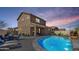 Backyard view of a refreshing pool with rock waterfall feature and covered patio at 778 W Lowell Dr, San Tan Valley, AZ 85140
