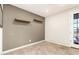 A bright room with wood shelves, neutral walls, and a door to the outside at 778 W Lowell Dr, San Tan Valley, AZ 85140