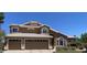 Charming two-story home with a two car garage and well-maintained landscaping, under a clear sky at 927 S Paradise Dr, Gilbert, AZ 85233