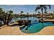Spectacular pool and spa overlooking a lake with palm trees, boats and waterfront properties in the background at 927 S Paradise Dr, Gilbert, AZ 85233