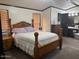 This bedroom features a wooden bed frame and a spacious walk-in closet at 9302 E Broadway Rd # 129, Mesa, AZ 85208
