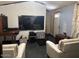 Cozy living room featuring neutral paint, a flat-screen TV, and modern furniture at 9302 E Broadway Rd # 129, Mesa, AZ 85208