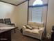 Comfortable living space offering a cozy sofa and plenty of natural light at 9302 E Broadway Rd # 129, Mesa, AZ 85208