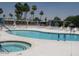 Sparkling pool and hot tub with lounge chairs and well-maintained deck for relaxation and leisure at 9302 E Broadway Rd # 129, Mesa, AZ 85208