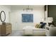 Bright bedroom with a comfortable bed, modern light fixture, and stylish decor at 9534 W Catalina Dr, Phoenix, AZ 85037