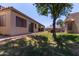 A view of the backyard featuring mature trees and partial landscaping at 1021 S Greenfield Rd # 1211, Mesa, AZ 85206