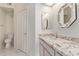 Bathroom with granite vanity top, decorative mirrors and marble floors at 1021 S Greenfield Rd # 1211, Mesa, AZ 85206