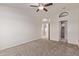 Spacious bedroom features neutral carpet, ceiling fan, and walk-in closet at 1021 S Greenfield Rd # 1211, Mesa, AZ 85206