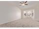 Cozy bedroom with neutral carpet, ceiling fan, and bright bay window at 1021 S Greenfield Rd # 1211, Mesa, AZ 85206