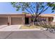 Charming single-story home featuring a two-car garage and mature shade tree in the front yard at 1021 S Greenfield Rd # 1211, Mesa, AZ 85206