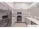 Modern kitchen features stainless steel appliances, gray cabinets, and granite countertops at 1021 S Greenfield Rd # 1211, Mesa, AZ 85206