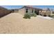 Large backyard with rock landscaping, a patio area and mature desert plants at 1133 E Viola Ct, Casa Grande, AZ 85122