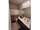 Bathroom with a single sink vanity, large mirror, tiled floors, and a shower-tub combination at 1133 E Viola Ct, Casa Grande, AZ 85122