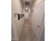 Bright hallway with tile flooring, white walls, and doors along the sides, leading to other rooms at 1133 E Viola Ct, Casa Grande, AZ 85122