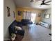 Cozy living room with neutral walls, tile flooring, comfortable seating, and a sliding glass door at 1133 E Viola Ct, Casa Grande, AZ 85122
