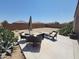 A covered patio with outdoor furniture and desert plants creates a comfortable backyard retreat at 1133 E Viola Ct, Casa Grande, AZ 85122