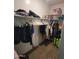 Walk-in closet with shelving, hanging rods, and carpeted flooring for organized storage at 1133 E Viola Ct, Casa Grande, AZ 85122