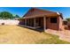 Backyard with screened in patio and brick pathway at 11338 E Contessa St, Mesa, AZ 85207