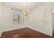 Bright formal dining room with wood floors and a decorative chandelier at 11338 E Contessa St, Mesa, AZ 85207