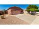 A cozy home with desert landscaping and a spacious two-car garage and concrete driveway at 11338 E Contessa St, Mesa, AZ 85207