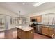 Open layout with granite island and stainless steel appliances seamlessly connect to a breakfast area at 11338 E Contessa St, Mesa, AZ 85207