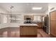 Open kitchen featuring stainless appliances, a granite island, and an adjacent dining area at 11338 E Contessa St, Mesa, AZ 85207