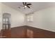 Spacious living room featuring wood floors, a ceiling fan, and natural light at 11338 E Contessa St, Mesa, AZ 85207