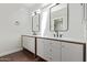 Bright bathroom featuring double sinks, modern lighting and dark wood trim at 122 S Hardy Dr # 62, Tempe, AZ 85281