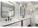 Bright bathroom featuring double sinks, modern lighting and dark wood trim at 122 S Hardy Dr # 62, Tempe, AZ 85281