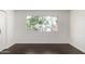 Bright bedroom featuring dark wood-look flooring, a large window and neutral walls at 122 S Hardy Dr # 62, Tempe, AZ 85281