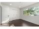 A simple bedroom with dark floors, white trim, a closet and a window at 122 S Hardy Dr # 62, Tempe, AZ 85281