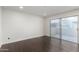 Bright bedroom featuring recessed lights, dark floors and sliding glass doors to the outside at 122 S Hardy Dr # 62, Tempe, AZ 85281