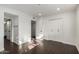 Bedroom with dark floors, white trim, a closet and doorway to an adjoining space at 122 S Hardy Dr # 62, Tempe, AZ 85281