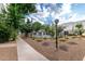 Attractive community pool area featuring flowering landscaping and mature shade trees at 122 S Hardy Dr # 62, Tempe, AZ 85281