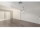 Open-concept dining space with wood-look floors and a modern white chandelier at 122 S Hardy Dr # 62, Tempe, AZ 85281