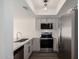 Modern kitchen with stainless steel appliances, white countertops, and shaker style cabinets at 122 S Hardy Dr # 62, Tempe, AZ 85281