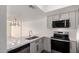 Modern kitchen with stainless steel appliances, white countertops, and two-tone shaker style cabinets at 122 S Hardy Dr # 62, Tempe, AZ 85281