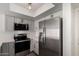 Modern kitchen with stainless steel appliances, white countertops, and two-tone shaker style cabinets at 122 S Hardy Dr # 62, Tempe, AZ 85281