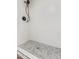 Updated shower stall with white tiled walls and pebble stone shower floor at 122 S Hardy Dr # 62, Tempe, AZ 85281